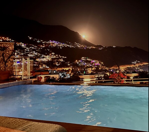 A nighttime view of a pool area with a mountain backdrop. - Villa with pool - centrally located (Klakan)