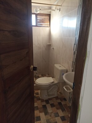 A bathroom with a toilet, bidet, and a shower area. - Hotel Tota Eliseo Playa Blanca (Tota)