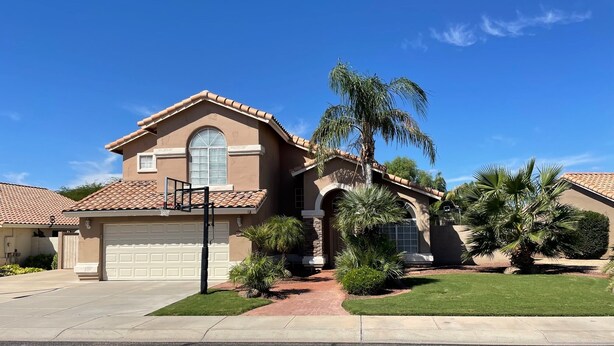 A two-story house with a garage, a basketball hoop, and a well-maintained lawn. - Spacious family home with private pool in a safe, quiet neighborhood. (Glendale)