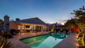 A backyard with a swimming pool, patio furniture, and a covered outdoor seating area. - Scottsdale Gem - Remodeled, Pool, Hot Tub (Scottsdale)