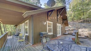 A wooden deck with outdoor furniture, a barbecue grill, and a satellite dish. - Secluded Vian Retreat Close to Tenkiller Lake (Vian)