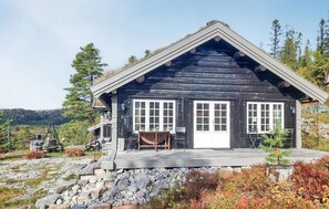 A rustic cabin with a wooden exterior, a front porch, and a stone foundation. - 3 bedroom nice home in Eggedal (Eggedal)