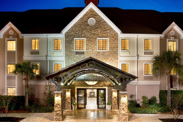 Stunning hotel with a unique architectural style, featuring a symmetrical design and beautiful gardens.