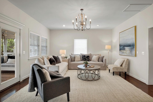 This beautiful living space leads to our large indoor back porch