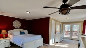 A bedroom with a bed, nightstand, dresser, and a ceiling fan. - Gilford Central Retreat - For all your Vacation Needs! (Gilford)