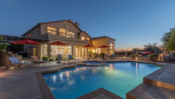 A large house with a swimming pool, outdoor seating, and umbrellas. - LUX Near Golf & Trails: Pvt POOL/Spa, Wood FP, Game Tables, TVs All BRs, EV Charger (Mesa)
