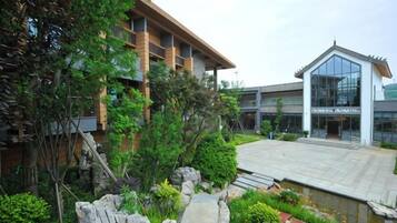 A building with a modern architectural style, a stone pathway, and a small water feature.