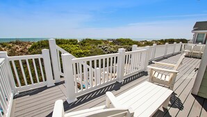 A wooden deck with white railings, a bench, and a table. - OCEANFRONT, Private Pool, Pool Table, Ocean Views, BU70, Kings Landing (Corolla)