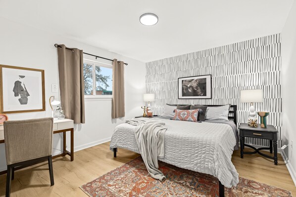 Spacious bedroom offers natural light, as well as black out curtains