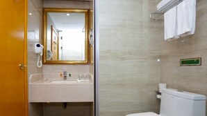 A bathroom with a sink, mirror, toilet, and towel rack. - Vienna International Hotel Nanning Wuyi Fude (Nanning)