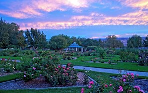 A garden with a gazebo, well-maintained lawns, and flowering plants. - Mtn+City Views | 4BR Firepit FamilyRetreat NearUNR (Reno)