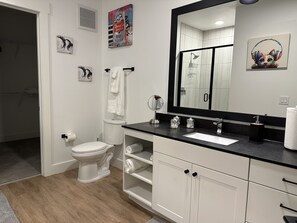 Shower, hair dryer, towels, toilet paper