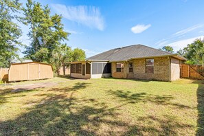 A single-story house with a brick exterior, a front door, and a covered patio area. - Sweet Home Alabama (Foley)