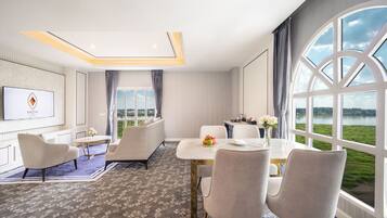 Suite River View | Área de sala de estar | Televisión LED de 32 pulgadas con canales vía satélite y televisión