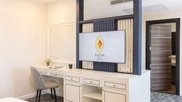 A hotel reception desk with a modern design, a large mirror, and a logo for Eastin Hotel.