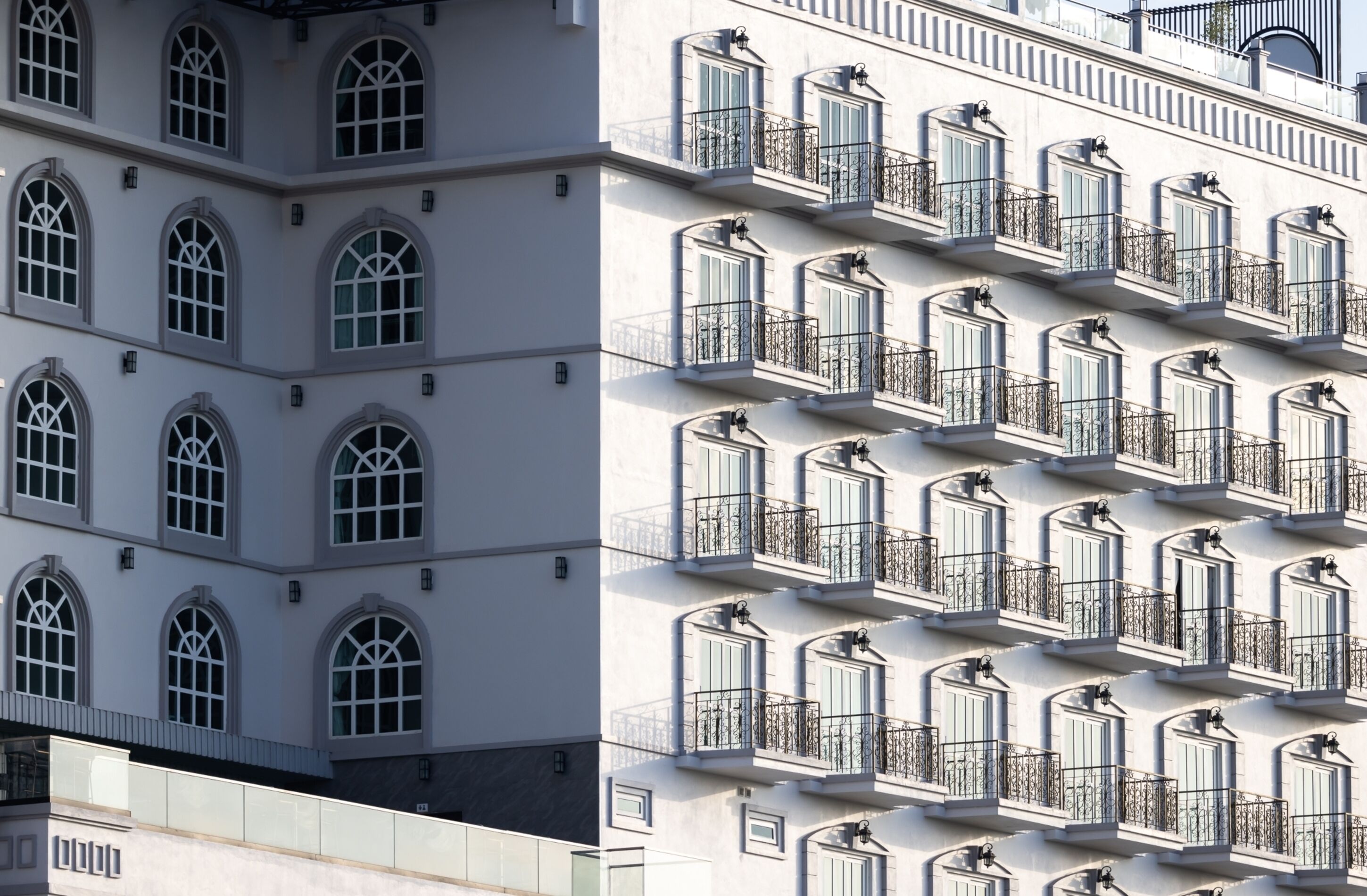A building with multiple balconies and arched windows.