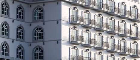 A building with multiple balconies and arched windows.
