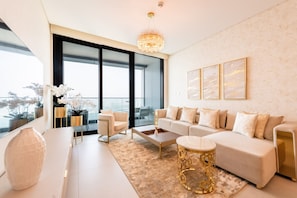 A modern living room with a sofa, coffee table, and decorative items.