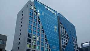 A modern Union Hotel building with a distinctive glass facade and a prominent 'Union Hotel' sign.