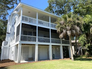 A two-story building with a balcony and a covered porch area.