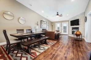 Relax in this inviting living area with a fireplace, dining table, and comfortable sofa.