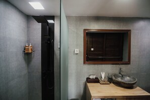 A bathroom with a wooden vanity, a large mirror, and a built-in shower. - Gama's Villa (Tabanan)