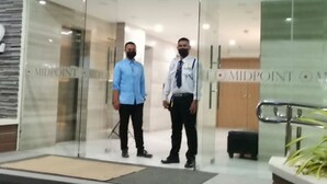 Two men standing in a glass door entrance with the text "MIDPOINT" visible. - Enjoy the luxury and comfort of living (Cebu)