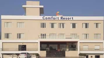 A multi-story building with a sign reading "Comfort Resort".
