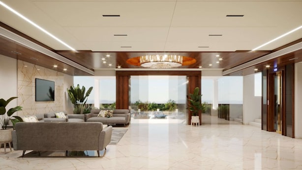 A spacious lobby with a modern chandelier, large windows, and a seating area with sofas and plants.