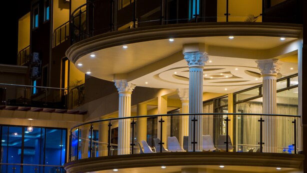 A multi-level hotel interior with a grand staircase, seating areas, and large windows. - Hotel Horizon Entebbe (Entebbe)