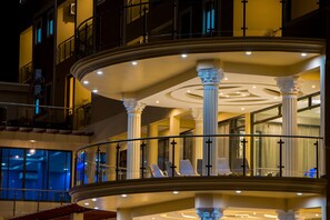 A multi-level hotel interior with a grand staircase, seating areas, and large windows. - Hotel Horizon Entebbe (Entebbe)