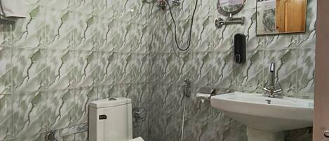 A bathroom with a toilet, sink, and a water heater mounted on the wall.