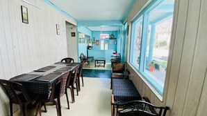 A reception area with a reception desk, a clock, and a sign indicating the reception. - Hotel Meadows (Manali)