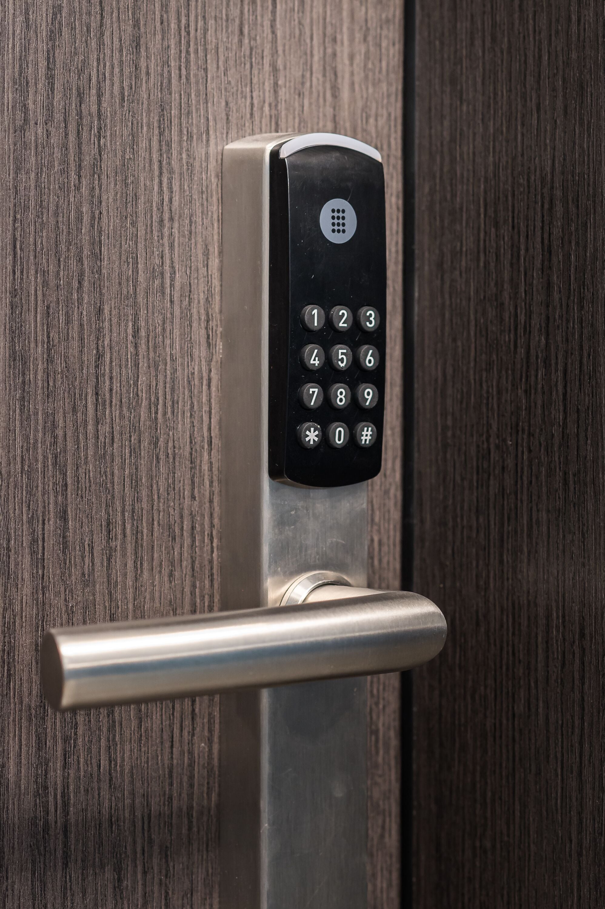 A modern door with a numeric keypad lock.