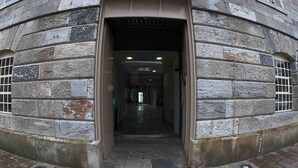 A stone building entrance with a sign indicating restricted access. - Cozy Coastal Apartment (Plymouth)