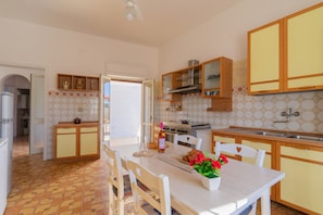 Enjoy cooking and dining in this well-equipped kitchen with modern appliances and a spacious dining area.