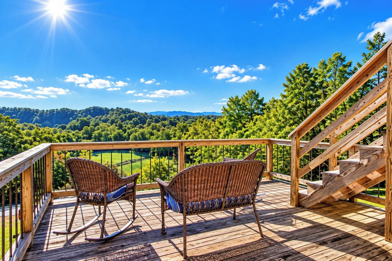 A wooden deck with wicker chairs and a staircase.
