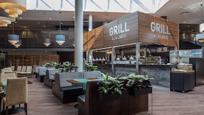 Un restaurant moderne avec une façade en bois et une enseigne indiquant « GRILL A LA CARTE ».