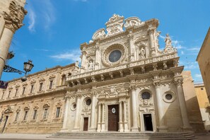 A historic building with ornate architectural details, including columns, statues, and decorative elements.