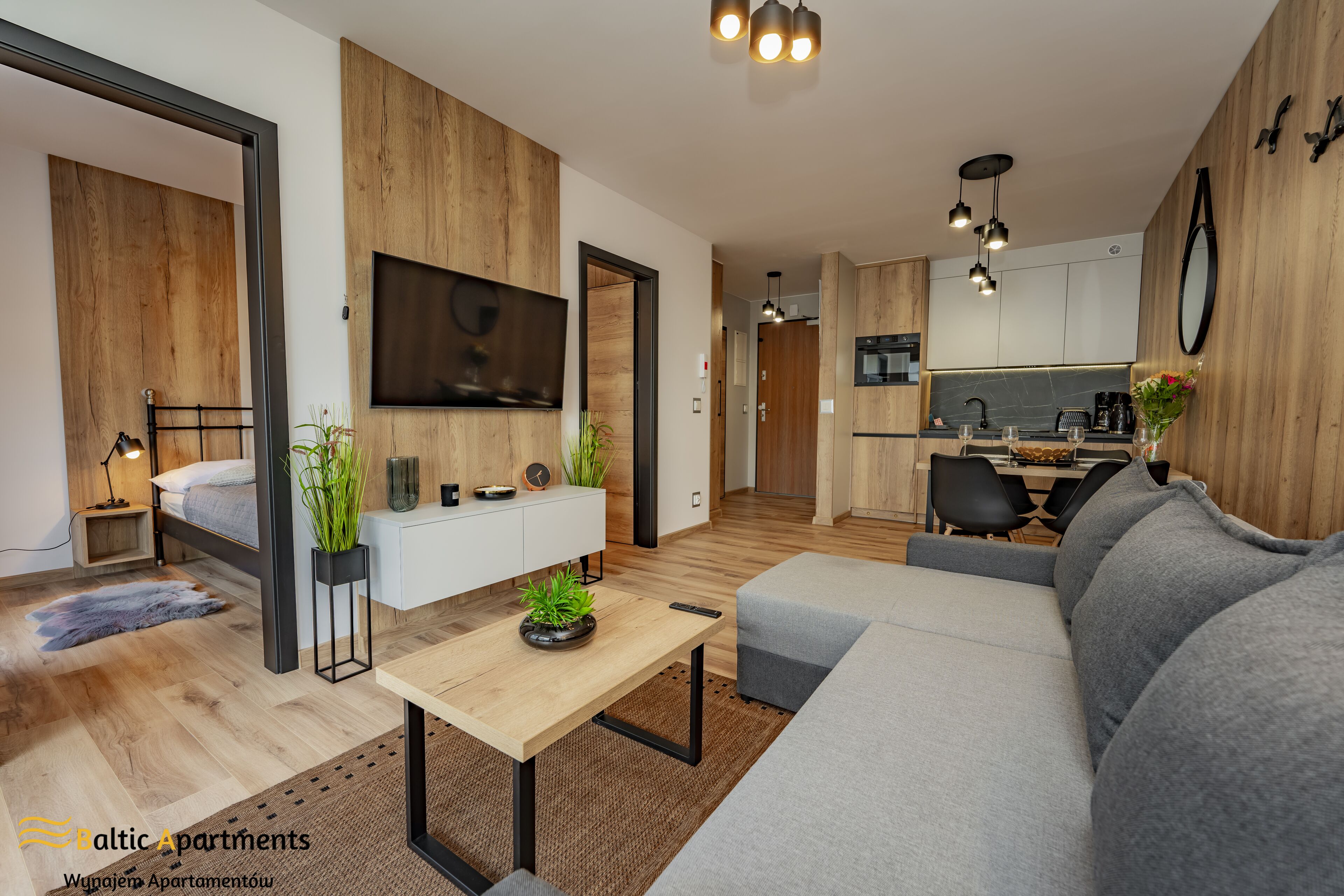A modern apartment with a living room, dining area, and kitchen.