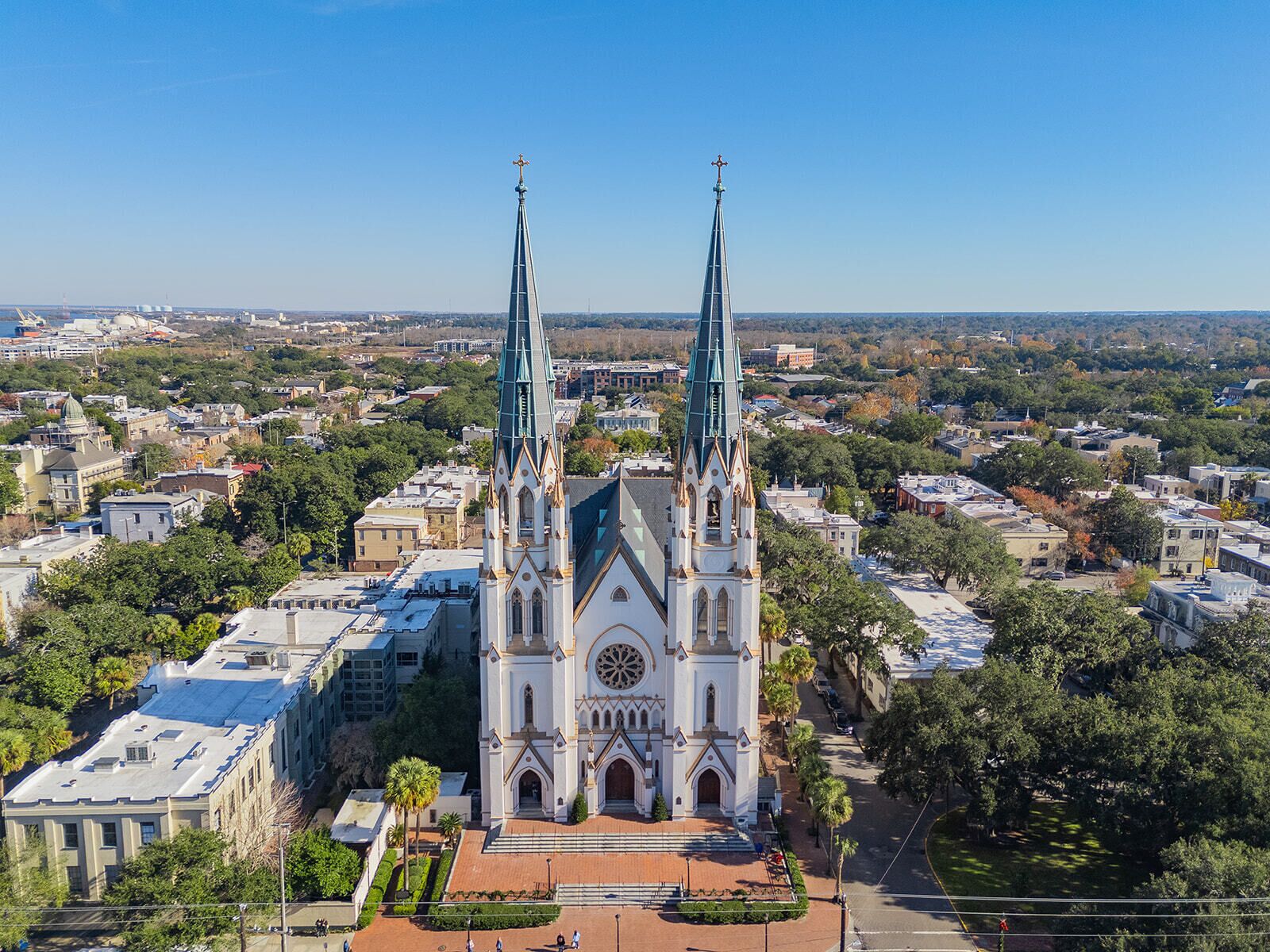 A large church with two tall spires, surrounded by a cityscape.