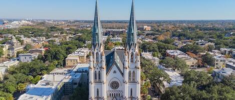 A large church with two tall spires, surrounded by a cityscape.