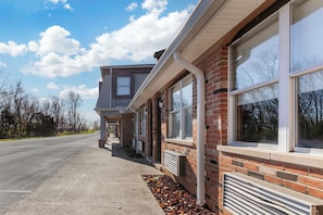 A two-story building with a brick facade and large windows. - Red Roof Inn Georgetown, KY (Georgetown)