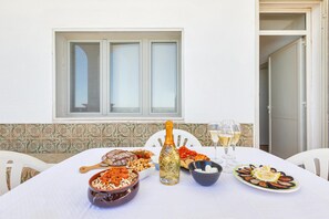 A dining table with various dishes, a bottle of champagne, and glasses of wine.