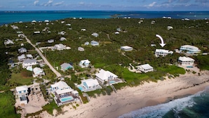 An aerial view of a coastal residential area with houses, a beach, and the ocean. - Kokomo Cay - Luxurious Home Near the Beach, with Spectacular Ocean Views (Hope Town)