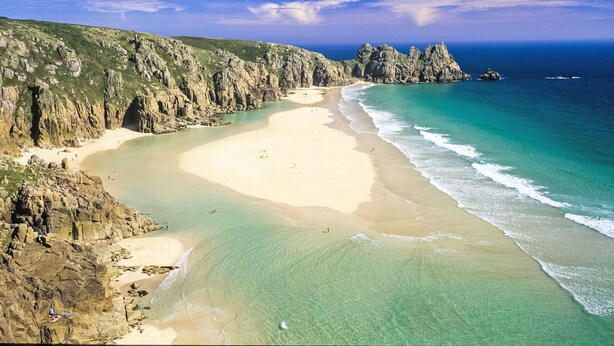 A coastal landscape with a sandy beach, rocky cliffs, and clear blue waters. - Stones Throw by Interhome (Charlestown)