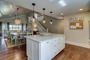 A spacious kitchen with a central island, pendant lighting, and a view to the dining area. - 12 Portside Drive-Views, Views!!!  Braddock Cove and South Beach Marina (Hilton Head Island)