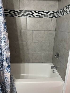 Combined shower/tub, hair dryer, towels, soap