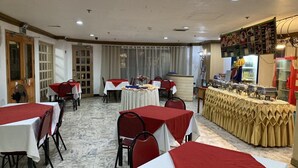 A dining area with tables set for service, a buffet line, and a menu board. - Demiren Hotel and Restaurant (Cagayan de Oro)