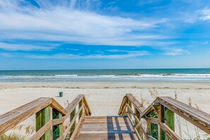 Walk along the boardwalk to the sandy beach.